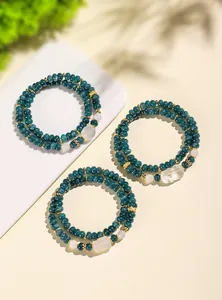 Detailed view of three double-strand chalcedony bracelets with fox and Pixiu charms.