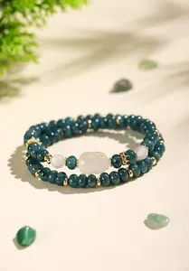 Detail view of a dark green chalcedony double-layer bracelet with a white fox charm