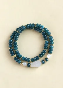 Detailed view of a double-strand jadeite beaded bracelet with a white fox charm.