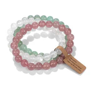 Set of three natural stone beaded bracelets in pink, green, and white crystal colors