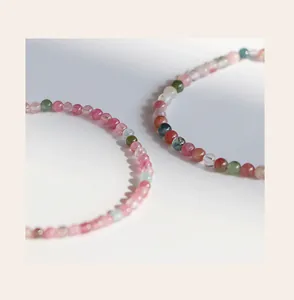 Detailed close-up of 3mm natural rainbow tourmaline beaded rings with soft lighting