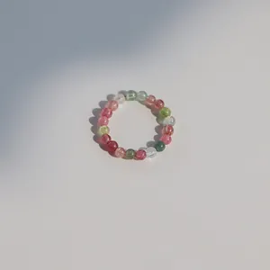 Macro view of 3mm mini natural rainbow tourmaline beaded ring with vibrant gemstones.