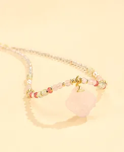 Detailed view of the rose quartz square pendant and mixed prehnite beads necklace.