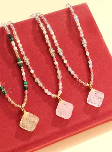 Close-up of three handcrafted New Chinese style beaded necklaces with crystal pendants.