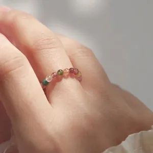 Exquisite 3mm natural rainbow tourmaline gemstone bead ring worn on a woman's finger