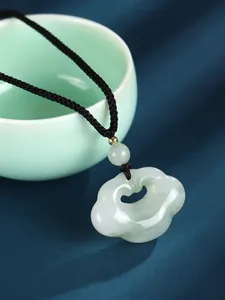 Detailed view of traditional Chinese Ruyi lock jade pendant on a black braided cord