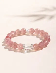 Detailed macro shot of a strawberry quartz and clear crystal beaded bracelet