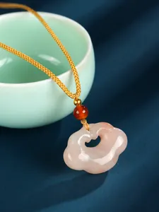 Detail view of cloud-shaped jade pendant with traditional Chinese Ruyi lock design style.
