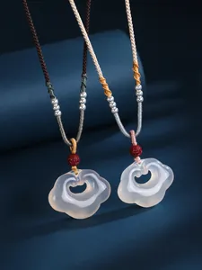 Detailed view of white agate Ruyi lock cloud pendant necklaces with silver beads