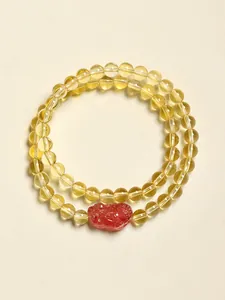 Détail du bracelet double rang avec perles de quartz rutilé doré et quartz fraise rouge