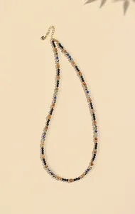 Close-up of 4mm natural lapis lazuli and black agate beaded necklace with gold spacers