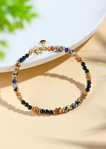 Close-up of 4mm natural lapis lazuli and black agate beaded bracelet with gold clasp