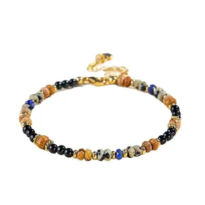 4mm natural lapis lazuli and black agate beaded bracelet with gold spacers on white background