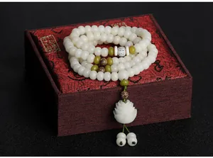 Detailed view of natural Bodhi root 108-bead prayer bracelet with a white lotus charm