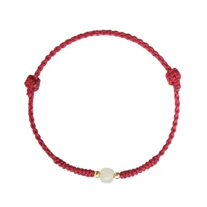 Handmade red rope bracelet with natural Hetian jade bead for luck and protection.