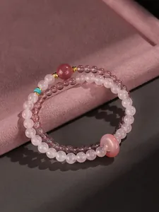 Close-up of elegant double-strand rose quartz bracelet with detailed pink donut charm