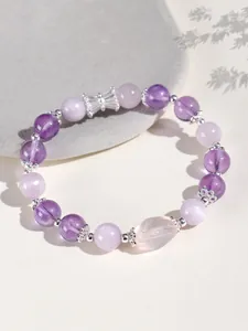 Detailed view of 8mm amethyst and pink crystal beaded bracelet with silver charms