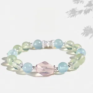 Close-up detail of multi-gemstone beaded bracelet featuring rose quartz and aquamarine beads
