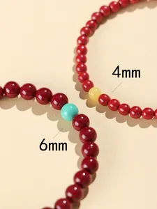 Macro view comparing 4mm and 6mm red cinnabar beads with turquoise accent stones