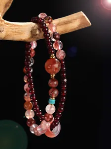 Close-up of double-layer beaded bracelet with red garnet and pink strawberry quartz