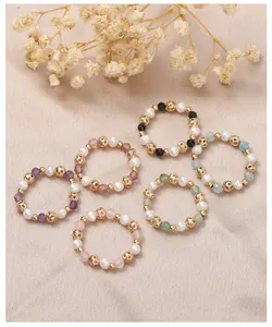 Detailed view of six handmade natural freshwater pearl and colorful crystal beaded rings