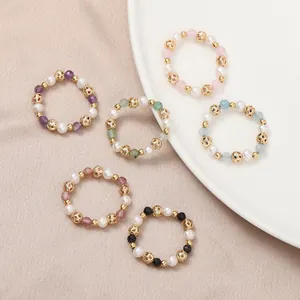 Elegant natural freshwater pearl and colorful crystal elastic rings on neutral background