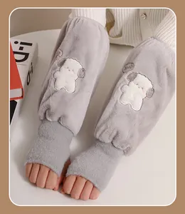 Close-up of cute plush gray oversleeves with cartoon dog patch on hands