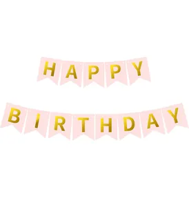 Close-up detail of a pink and gold Happy Birthday banner for children party decorations