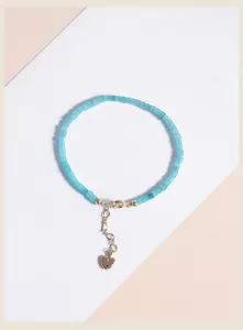 Close-up of a delicate 2mm natural Amazonite bead bracelet with gold heart charm