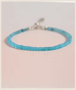Macro view of 2mm square natural Amazonite beads on a minimalist silver clasp bracelet