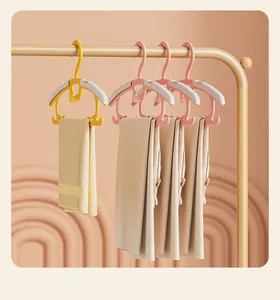 Adjustable non-slip children's hangers on a clothing rack with towel and clothes