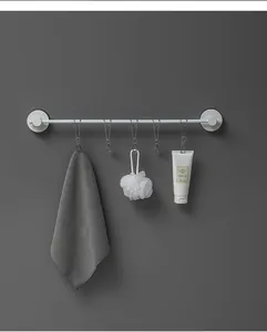 Wall-mounted white bathroom storage rod with five stainless steel clips for towel and loofah