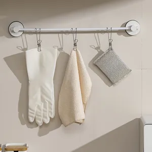 Multi-purpose stainless steel laundry clips with hooks for towel and glove storage.