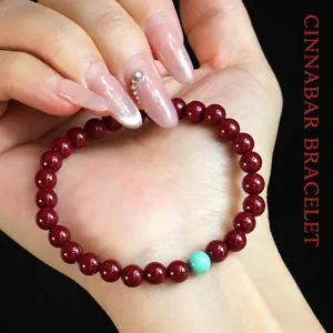Natural red cinnabar bead bracelet for women featuring a single turquoise lucky bead accent