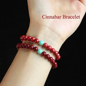 Elegant red cinnabar bead bracelet set featuring turquoise accent beads on wrist display