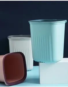 Set of minimalist square trash cans with vertical stripe texture in various colors
