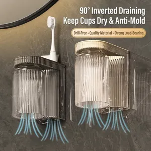 Wall-mounted toothbrush holder with two fluted cups and adhesive mount for bathroom