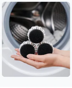 Three black and white anti-tangle laundry balls for washing machines shown in hands