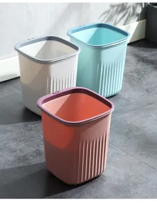 Detail view of square trash cans in three colors with striped textures and rim rings