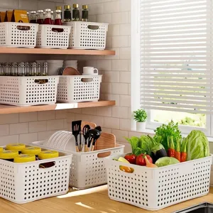 Set of versatile white perforated plastic storage baskets for organized kitchen storage