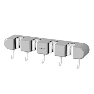 Grey wall-mounted mop and broom holder with 5 hooks and 4 slots, no-drill adhesive