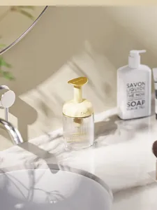 Detail view of a creamy yellow manual foam maker for facial cleanser on a marble counter