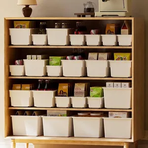 White plastic storage bins for cabinet and pantry organization in a wooden shelf display.