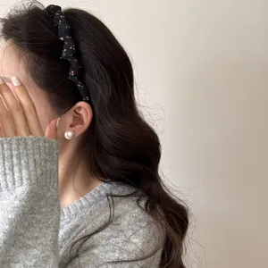Close-up of retro floral fabric headband on wavy hair showing aesthetic skull-heightening effect