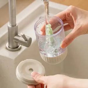 Clear press-type salt control bottle being rinsed under a faucet for easy and quick cleaning