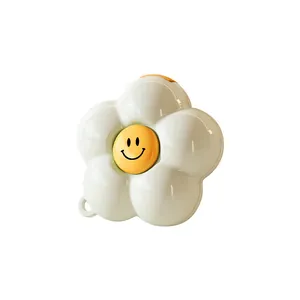 Mini flower-shaped jewelry organizer box with a cute smiley face for travel storage