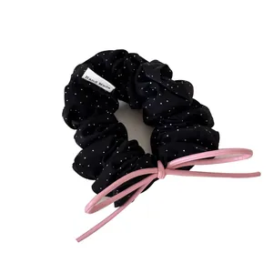 Elegant black polka dot scrunchie hair tie decorated with a cute pink leather bow