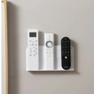 Wandmontiertes Aufbewahrungsregal ohne Bohren für TV- und Klimaanlagen-Fernbedienungen.