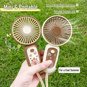 Portable USB rechargeable handheld mini fans with cute cartoon stickers on green grass