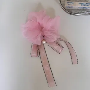 Elegant pink organza flower scrunchie with pearl and long ribbon macro detail